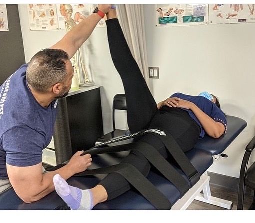 Assisted Fascial Stretch Therapy on a treatment table