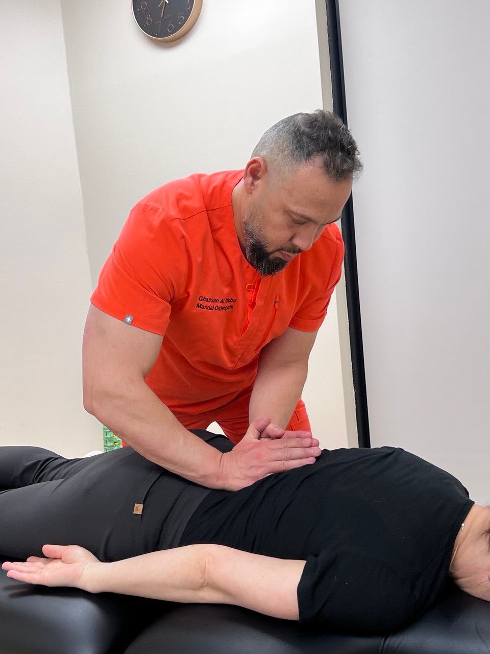 Ghassan treating a patient's lower back