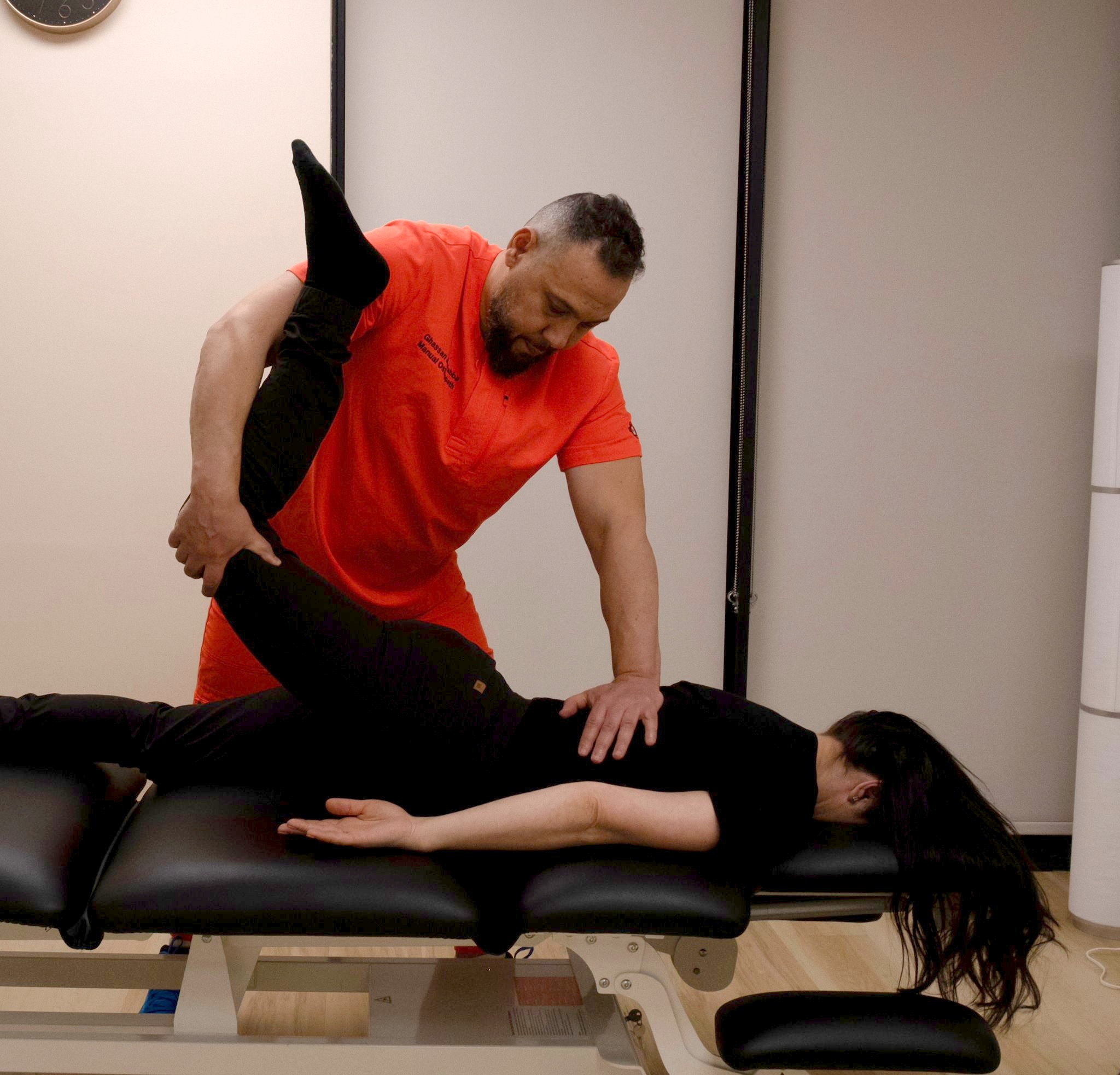 Ghassan treating a patient's back and hip