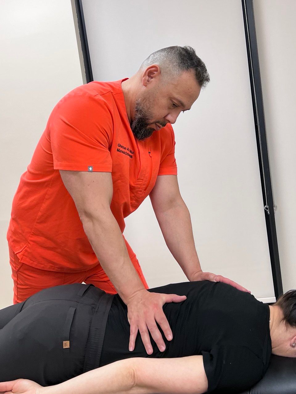 Ghassan treating a patient's back
