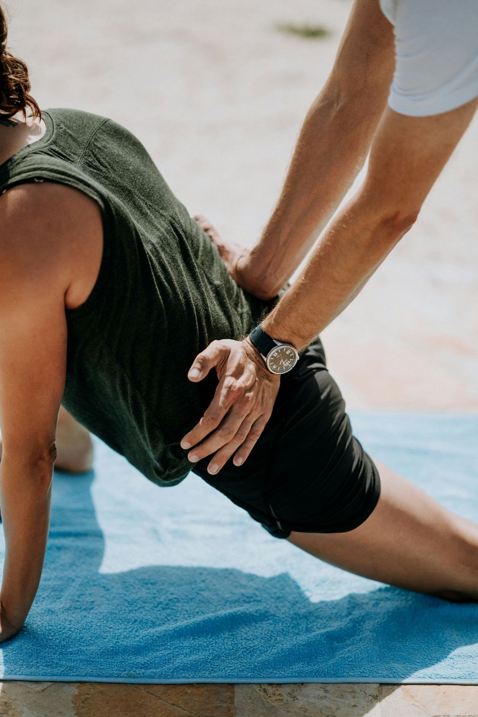 Hands-on guidance through a lunge and hip stretch