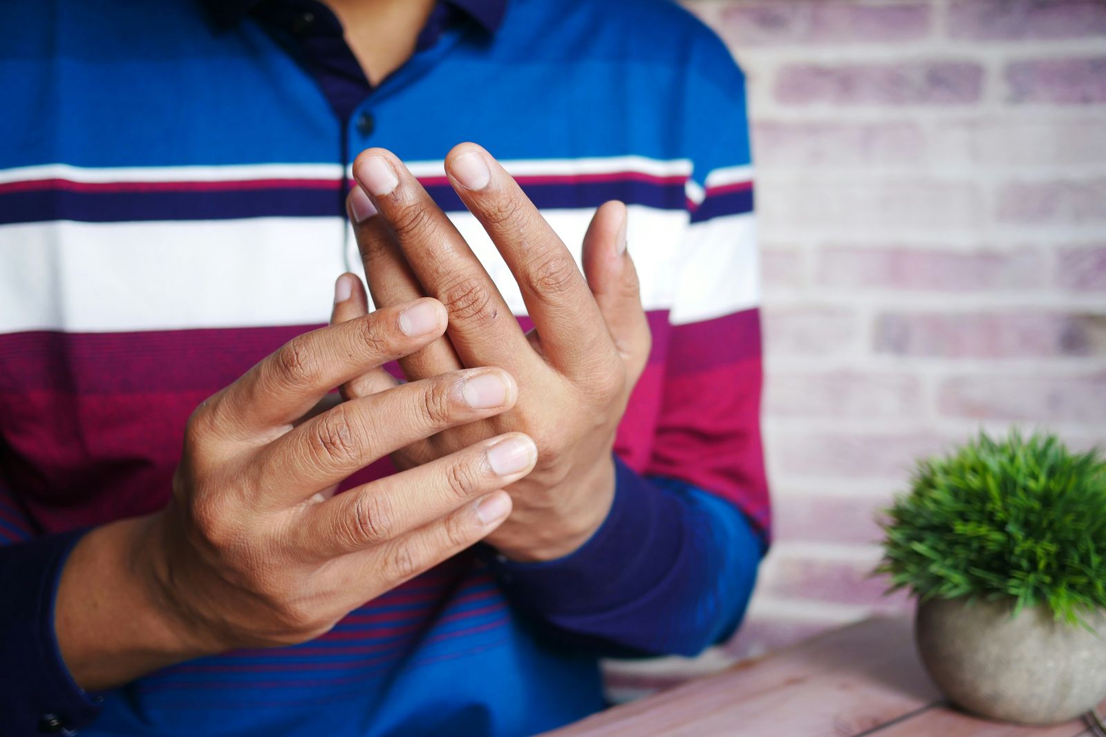 Hands holding sore finger joints